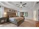 A spacious main bedroom boasts a tray ceiling, ceiling fan, and an attached sitting room at 2772 Hillgrove Dr, Dacula, GA 30019
