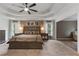 Elegant main bedroom featuring a tray ceiling, ceiling fan, neutral walls, and bright, natural light at 2772 Hillgrove Dr, Dacula, GA 30019