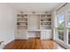 Office space with built-in shelves and cabinets for storage, filled with natural light from large windows at 2772 Hillgrove Dr, Dacula, GA 30019