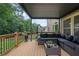 Covered patio with wooden floors and outdoor furniture with green grass and backyard views at 2772 Hillgrove Dr, Dacula, GA 30019