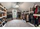 A capacious walk-in closet features expansive shelving, hanging rods, and abundant storage at 2772 Hillgrove Dr, Dacula, GA 30019