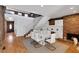 Open-concept dining area with fireplace, a modern staircase, and bright hardwood flooring at 549 Ne Parkway Ne Dr, Atlanta, GA 30308