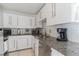 Modern kitchen featuring white cabinets, granite countertops, and stainless steel appliances at 549 Ne Parkway Ne Dr, Atlanta, GA 30308