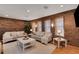 Cozy living room with exposed brick wall, plush seating, and abundant natural light at 549 Ne Parkway Ne Dr, Atlanta, GA 30308