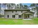 Spacious backyard featuring a covered patio, green grass, and vinyl siding on the two-story home at 165 Cooper E Cv, Fayetteville, GA 30215