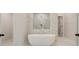Modern bathroom featuring a freestanding tub, marble surround shower, and sleek fixtures at 165 Cooper E Cv, Fayetteville, GA 30215