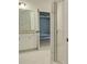 Modern bathroom with white marble floors, a glass shower door, and granite counters and vanities at 165 Cooper E Cv, Fayetteville, GA 30215