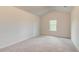 Spacious bedroom featuring neutral carpet, vaulted ceiling, and natural light from a window at 165 Cooper E Cv, Fayetteville, GA 30215