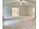 Bright, spacious bedroom with a ceiling fan, neutral walls, and a view into the luxurious bathroom at 165 Cooper E Cv, Fayetteville, GA 30215