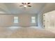 Bright bedroom with neutral walls, plush carpet, and ceiling fan; has large windows for ample light at 165 Cooper E Cv, Fayetteville, GA 30215