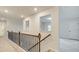 Upstairs hallway featuring wood and iron railing, recessed lights, and architectural window at 165 Cooper E Cv, Fayetteville, GA 30215