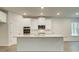 Modern kitchen featuring an island with granite countertop, stainless appliances, and white cabinets at 165 Cooper E Cv, Fayetteville, GA 30215