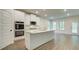 Beautiful open-concept kitchen with stainless steel appliances and a large island with granite countertops at 165 Cooper E Cv, Fayetteville, GA 30215