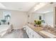 Double sink bathroom features a granite countertop, neutral paint, and plenty of natural light at 1752 Shadybrook Ct, Lawrenceville, GA 30043