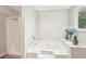 Bright bathroom featuring a tub with jets and a shower cabin, with a big window at 1752 Shadybrook Ct, Lawrenceville, GA 30043