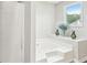 Bright bathroom featuring a tub with jets and a shower cabin, with a big window at 1752 Shadybrook Ct, Lawrenceville, GA 30043