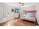 Bright bedroom with hardwood floors, a pink bunk bed, and big windows with curtains at 1752 Shadybrook Ct, Lawrenceville, GA 30043