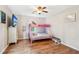 Bright bedroom with hardwood floors, a pink bunk bed, and big windows with curtains at 1752 Shadybrook Ct, Lawrenceville, GA 30043