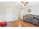 Cozy Bedroom with hardwood floors, a ceiling fan, and a gray crib at 1752 Shadybrook Ct, Lawrenceville, GA 30043