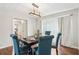 Cozy dining area with a classic dark wood table, blue upholstered chairs, and ample natural light at 1752 Shadybrook Ct, Lawrenceville, GA 30043