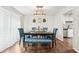 Elegant dining room featuring stylish blue chairs, bench seating, and modern lighting at 1752 Shadybrook Ct, Lawrenceville, GA 30043