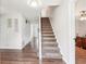 Spacious entryway featuring hardwood floors and carpeted stairs leading to the upper level at 1752 Shadybrook Ct, Lawrenceville, GA 30043
