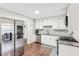 Bright kitchen features white cabinets, stainless steel appliances, and a decorative backsplash at 1752 Shadybrook Ct, Lawrenceville, GA 30043