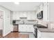 Bright kitchen features white cabinets, stainless steel appliances, and a decorative backsplash at 1752 Shadybrook Ct, Lawrenceville, GA 30043