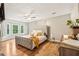 Spacious main bedroom offers natural light, stylish furnishings, and wood-look laminate flooring at 1752 Shadybrook Ct, Lawrenceville, GA 30043