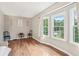 Sitting area offers natural light, neutral paint, wood-look laminate flooring and minimalist decor at 1752 Shadybrook Ct, Lawrenceville, GA 30043