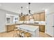 Bright kitchen features stainless appliances, an island with barstool seating and sleek pendant lighting at 272 Rockledge Sw Bnd, Powder Springs, GA 30127