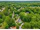 Aerial view of multiple homes nestled among mature trees, showcasing neighborhood layout and lush landscaping at 360 Spindle Ct, Sandy Springs, GA 30350