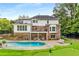 Amazing backyard with a swimming pool, putting green, and multiple spots for relaxing and lounging at 360 Spindle Ct, Sandy Springs, GA 30350