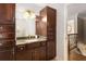 Bathroom features dark cabinets, granite counters, and a stairway visible in the mirror's reflection at 360 Spindle Ct, Sandy Springs, GA 30350