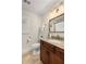 Bathroom with granite-topped vanity, decorative mirror, and a window with plantation shutters at 360 Spindle Ct, Sandy Springs, GA 30350