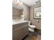 Bathroom vanity with quartz countertop, gold fixtures and gold framed mirror; natural light from the window at 360 Spindle Ct, Sandy Springs, GA 30350