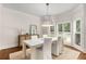 Elegant dining room with a modern chandelier, hardwood floors, and sunlit windows at 360 Spindle Ct, Sandy Springs, GA 30350