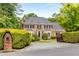 Traditional brick home with well-maintained landscaping, mature trees, and circular driveway at 360 Spindle Ct, Sandy Springs, GA 30350
