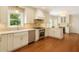 Bright kitchen featuring white cabinets, stainless steel appliances, and hardwood floors at 360 Spindle Ct, Sandy Springs, GA 30350