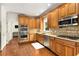 Kitchen with stainless steel appliances, wood cabinets, tile backsplash, and hardwood floors at 360 Spindle Ct, Sandy Springs, GA 30350