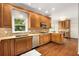Well-lit kitchen with wood cabinets, granite countertops, stainless steel appliances, and hardwood floors at 360 Spindle Ct, Sandy Springs, GA 30350