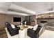 Spacious living room features a stone fireplace and wood-paneled accent wall with reclining chairs and modern decor at 360 Spindle Ct, Sandy Springs, GA 30350