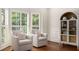 Cozy living room featuring two armchairs, plantation shutters, and a built-in display cabinet at 360 Spindle Ct, Sandy Springs, GA 30350