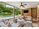 Relaxing covered patio featuring wood paneling, a ceiling fan, and comfortable seating area overlooking the pool at 360 Spindle Ct, Sandy Springs, GA 30350