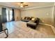 Comfortable living room with couch, tile floors, and light-filled patio door at 125 Rue Fontaine, Lithonia, GA 30038