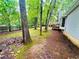 A spacious backyard with mature trees, a wooden fence, and lush greenery surrounding the property at 1905 Sidneys Cv, Lawrenceville, GA 30043