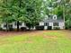 Charming single-story home with dormer windows and a lush, wooded front yard at 1905 Sidneys Cv, Lawrenceville, GA 30043
