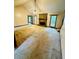 Bright living room featuring a stone fireplace, vaulted ceilings, and carpet at 1905 Sidneys Cv, Lawrenceville, GA 30043