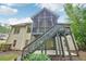 Two-story screened back porch and deck with stair access offers outdoor living space at 223 Falling Water Way, Woodstock, GA 30188