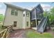 Backyard featuring a screened porch above and patio, accessible by stairs, offering ample outdoor living space at 223 Falling Water Way, Woodstock, GA 30188